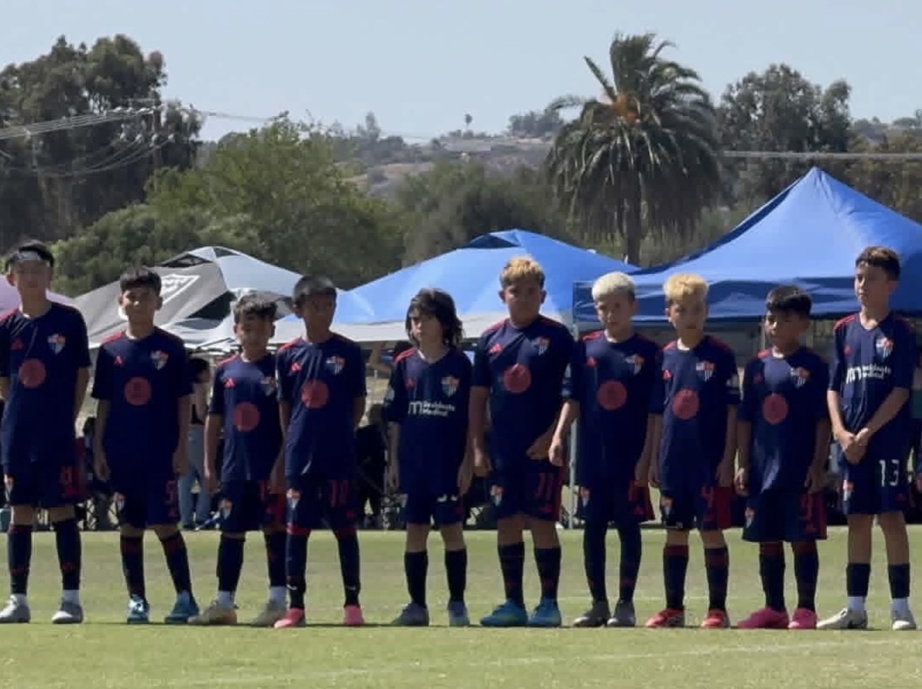 TFA-SELA BU11 Red players lined up on the soccer field